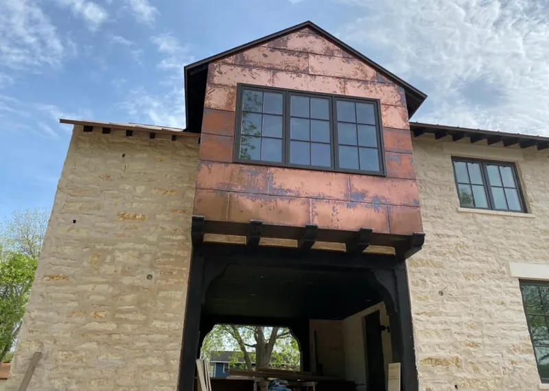 Copper metal panel facade on a stone building for Skylight Installation in Pontotoc