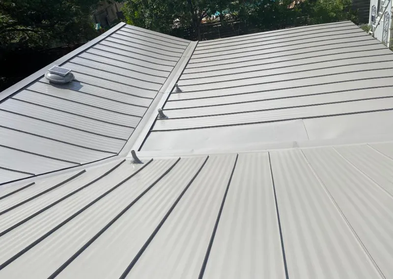 Solar attic fan installed on a metal roof for Roof Ventilation in Pontotoc